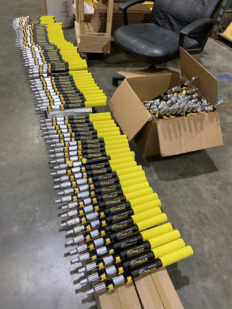 Rows of Saw Trax Pocket Reachers being prepared for final assembly